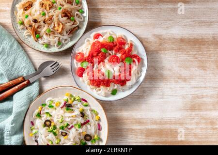 Konjac pasta with various vegetables, shot ftom the top with a place for text on a wooden background Stock Photo