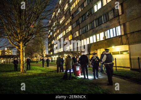 York Gardens, London, UK. 28th February 2021. The police comes over to disperse people under covid-19 social distancing rules. It is the end of a full week of tree-sitting for two tree protectors who occupy a 100-year-old black poplar tree due to be felled last Monday by Taylor Wimpey Homes and the Council of Wandsworth. People from the neighbourhood and activists 'are paying respect to the trees' with a peaceful ceremony at sunset “to show support to nature and to the protesters.'(Sabrina Merolla / Alamy Live News) Stock Photo