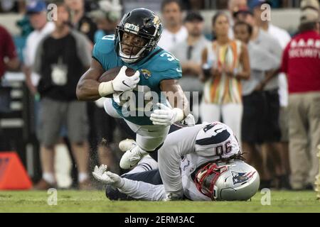 Jacksonville Jaguars running back Corey Grant, left, runs pass New Orleans  Saints linebacker Colton Jumper (58) during the first half of an NFL  preseason football game, Thursday, Aug. 9, 2018, in Jacksonville