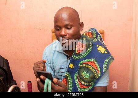 a man holding his phone and expressing himself Stock Photo