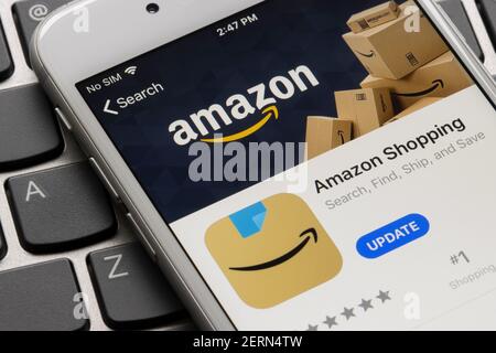Amazon shopping app is seen in the App Store on an iPhone. The new icon features its smile logo design, along with a hint of its blue packing tape. Stock Photo