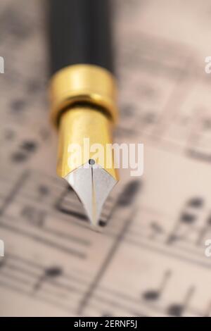 Fountain pen on music sheet Stock Photo