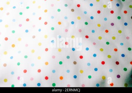 Fabric texture with multi-colored circles. Fabric background with pattern. Rainbow balls on the fabric. Stock Photo