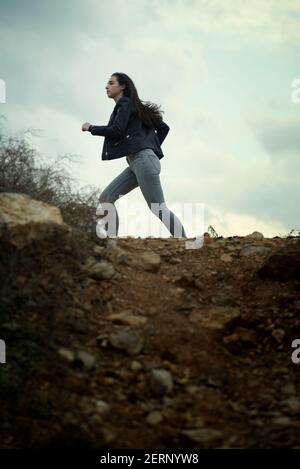 Young woman running away Stock Photo - Alamy