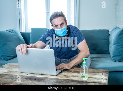 Stressed business man on laptop working from home looking worried, tired and overwhelmed. Exhausted entrepreneur working remotely during social distan Stock Photo