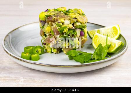 Seafood tuna fish ceviche salad avocado, lime, hot chili pepper, red onion, cilantro, sesame seeds Stock Photo