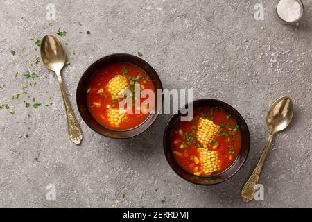 Tomato soup with corn and herbs diet lunch. Stock Photo