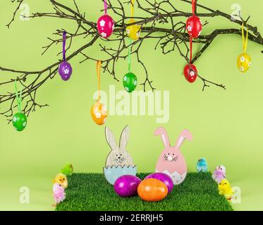 Easter tree, wooden bunny, and colored eggs. Holiday composition. Stock Photo