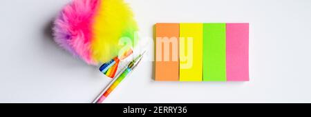 Colorful stationery. multicolored stickers and a pen on white background. banner Stock Photo