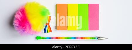 Colorful stationery. multicolored stickers and a pen on white background. banner Stock Photo