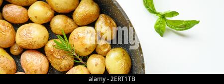 Golden roasted potatoes in the skin. banner Stock Photo