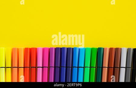 Colorful felt-tip pens on a yellow background. Colorfull concept for creativity. Stock Photo
