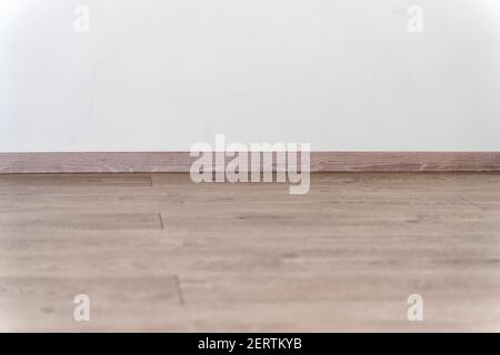 Copyspace background with empty white wall with hardwood floor with plenty of copy space for text or advertising Stock Photo
