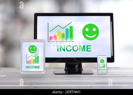 Income growth concept shown on different information technology devices Stock Photo