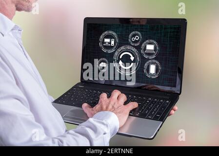 Man using a laptop with system update concept on the screen Stock Photo