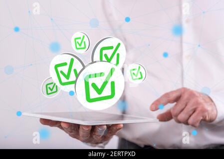 Validation concept above a tablet held by a man in background Stock Photo