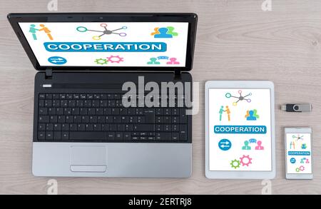 Cooperation concept shown on different information technology devices Stock Photo