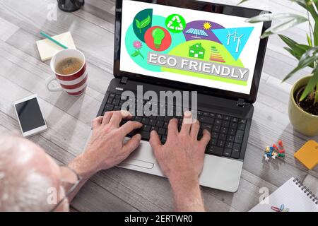 Eco friendly concept shown on a laptop used by a man Stock Photo