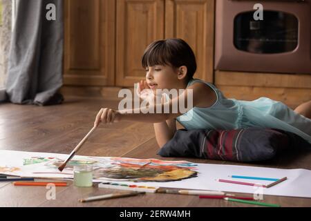 Small Latino girl child drawing at home Stock Photo