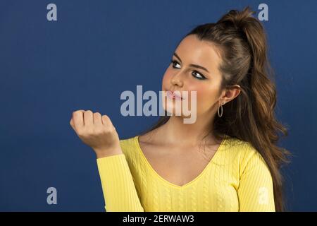 Closeup photo of lovely pretty lady wavy hairstyle stick  wearing yellow knitted sweater spring concept she is looking uo with her eyes. Stock Photo