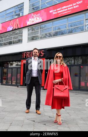 Heart radio presenters Amanda Holden and Jamie Theakston celebrate the return of Heart's 'Make Me a Millionaire' competition, outside the studios of Global Radio in Leicester Square, London. Picture date: Monday March 1, 2021. Stock Photo