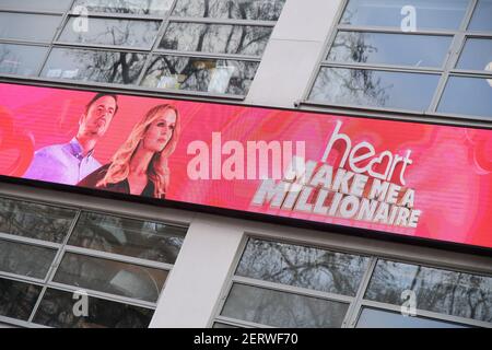 Heart radio presenters Amanda Holden and Jamie Theakston celebrate the return of Heart's 'Make Me a Millionaire' competition, outside the studios of Global Radio in Leicester Square, London. Picture date: Monday March 1, 2021. Stock Photo