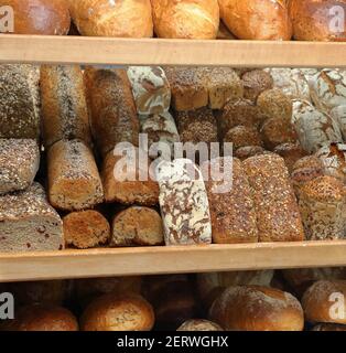 Fresh bread on shelves in a bakery store and empty space for text Stock Photo