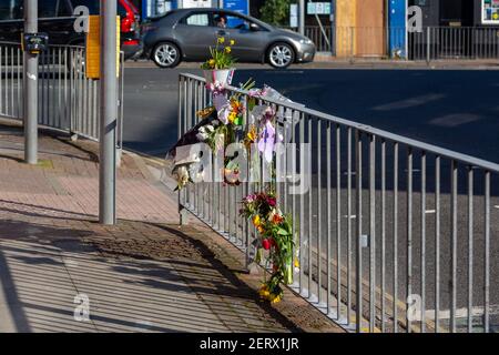 Flowers laid at the scene of a roadside accident Stock Photo