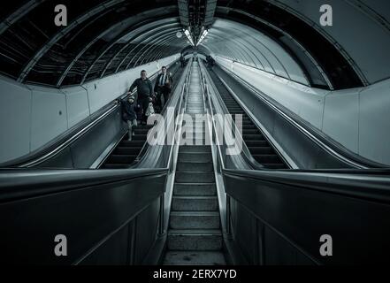 Commuters coming down a long old escalator at Bank Station on the London Underground, England Stock Photo