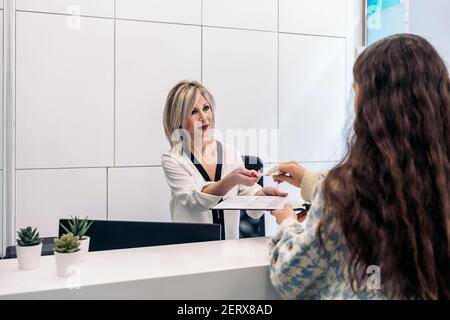 Stock photo of young woman arriving to her revision in dental clinic. Stock Photo