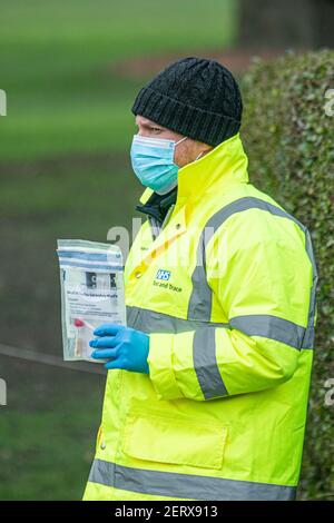 WIMBLEDON  LONDON, UK 01 March 2021. An NHS test and trace staff handing out a covid-19 kit at a testing centre in a car park in Wimbledon. It has been reported that six cases a Brazil coronavirus variant  known as P1 variant was  found in South Gloucestershire and Scotland in February..  Credit amer ghazzal/Alamy Live News Stock Photo