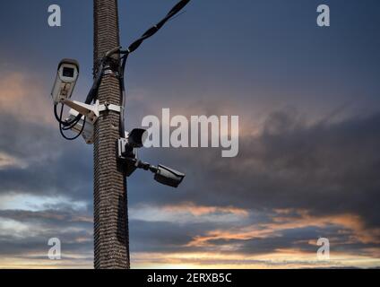 CCTV camera on the background of the sky with clouds. Stock Photo