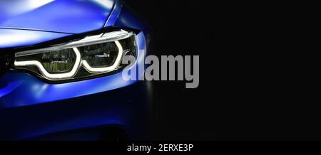 Close up detail blue modern car headlights with led technology on black background free space on right side for text. Stock Photo