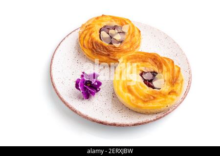 Small cheesecakes with jam and almonds isolated on white background. Side view, close up. Stock Photo