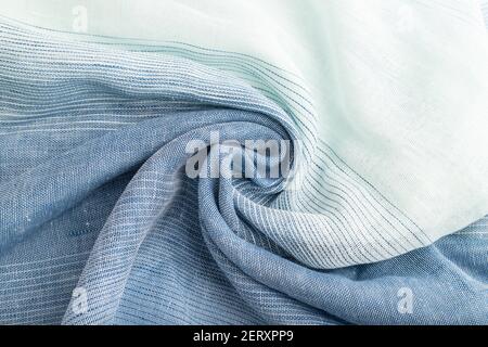 Fragment of blue linen tissue. Top view, natural textile background and texture. wave concept, abstract, spiral. Stock Photo