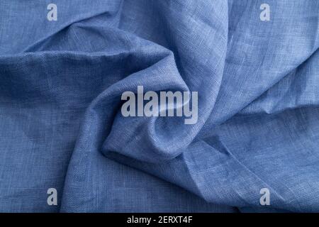 Fragment of blue linen tissue. Top view, natural textile background and texture. wave concept, abstract, spiral. Stock Photo