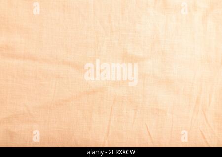 Fragment of smooth orange linen tissue. Top view, flat lay, natural textile background and texture. Stock Photo