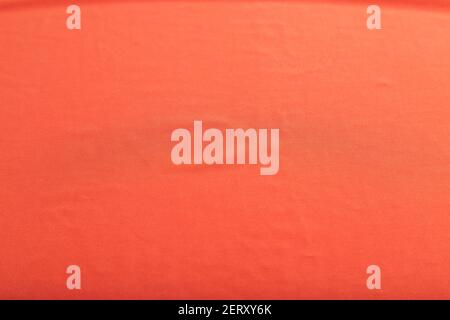 Fragment of smooth red silk tissue. Top view, flat lay, natural textile background and texture. Stock Photo