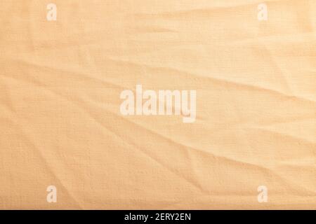 Fragment of smooth orange linen tissue. Top view, flat lay, natural textile background and texture. Stock Photo