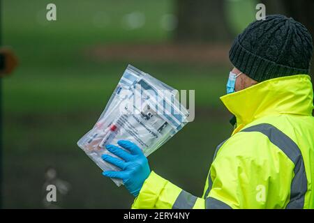 WIMBLEDON  LONDON, UK 01 March 2021. An NHS test and trace staff handing out a covid-19 kit at a testing centre in a car park in Wimbledon. It has been reported that six cases a Brazil coronavirus variant  known as P1 variant was  found in South Gloucestershire and Scotland in February..  Credit amer ghazzal/Alamy Live News Stock Photo