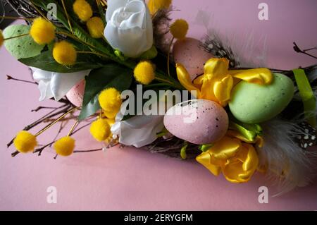 Part of easter wreath, decorated with flowers and eggs, made of birch branches. Stock Photo