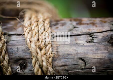 Closeup of rope tied around wood pole Stock Photo