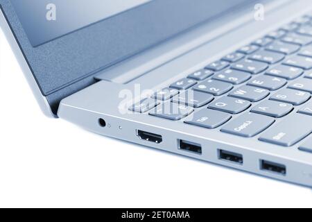Corner of laptop on white background close-up, toned in gray-blue color Stock Photo