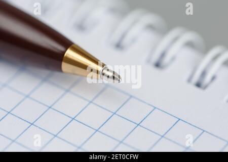 Ballpoint pen close-up on the background of a notepad with a spring Stock Photo