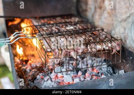 Cooking Ribs Over Open Fire Lamb ribs cooked over an open fire, close-up. Lamb chops Grilling ...