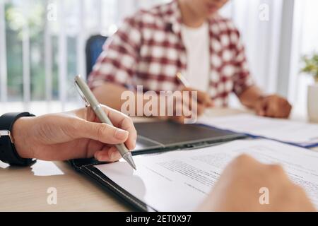 Business people discussing terms of contract Stock Photo