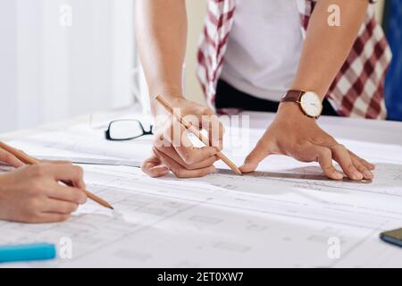 Architects working on construction plan Stock Photo