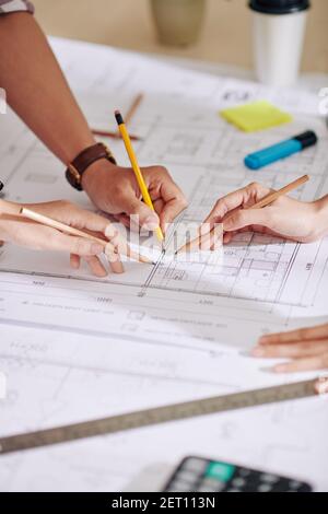 Construction engineers discussing construction plan Stock Photo