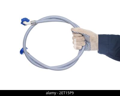Man plumber holds a drain hose in a washing machine on a white background, isolate. Close-up Stock Photo