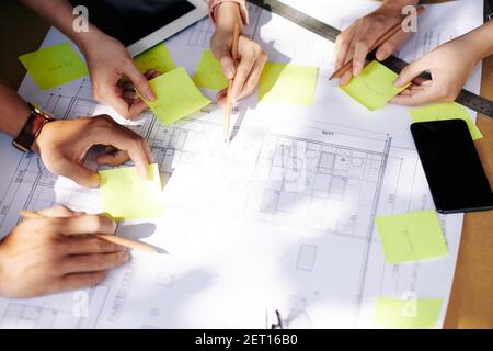 Creative team working with blueprint Stock Photo